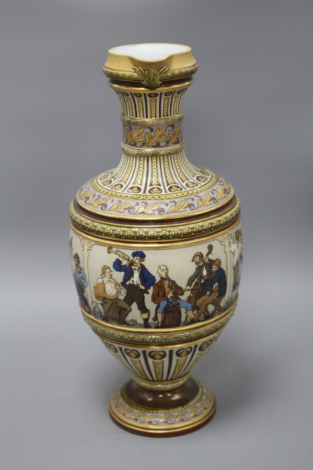A large Villeroy and Boch Mettlach ewer, decorated with figures drinking, dancing and musicians, impressed 1159, height 45cm